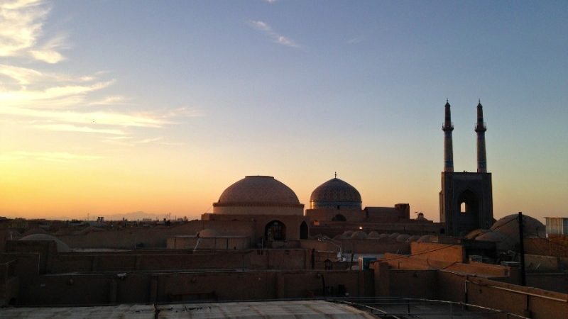 A skyline of temples and mosques at sunset