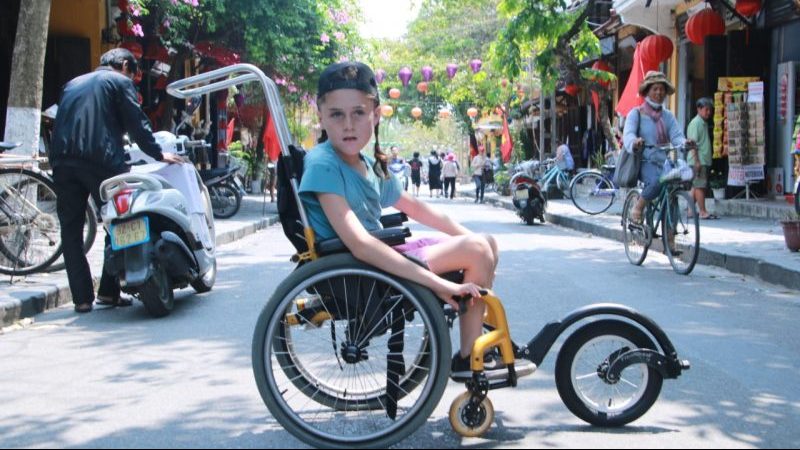 A young boy in his wheelchair