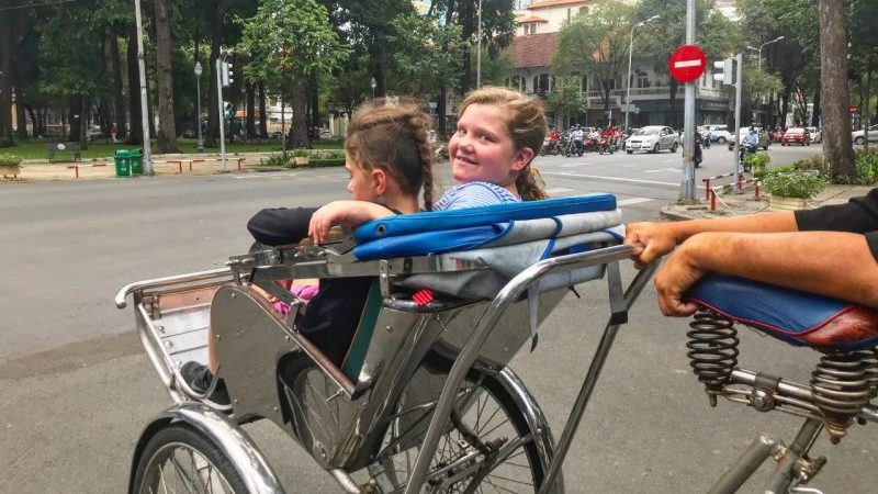 Two kids in a cyclo in Vietnam