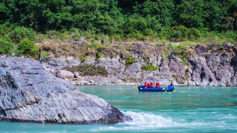 People in a river rafting boat on the Ganges river in India