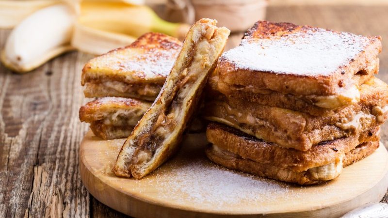 Grilled banana sandwiches on a wooden plate