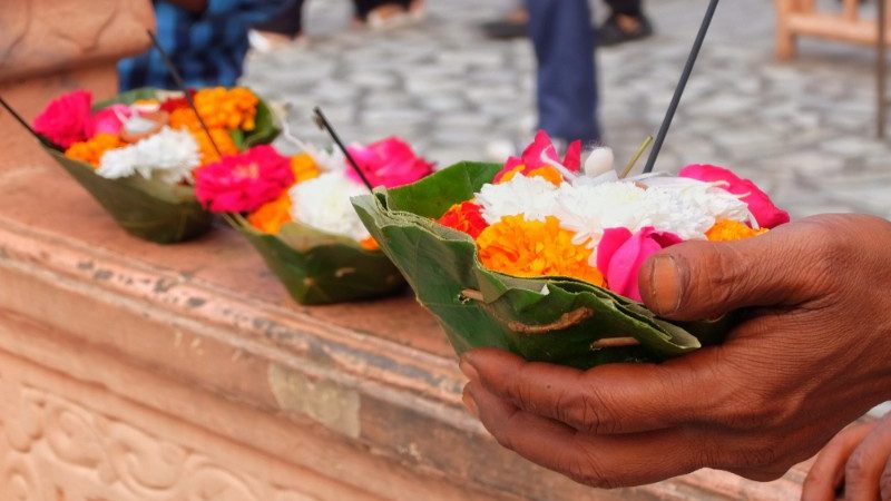 Image of a hand holding flowers to use in the ceremony.