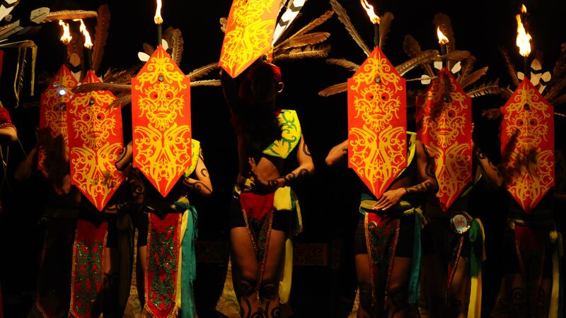 a group of Dayak dancers perform traditional warrior dance