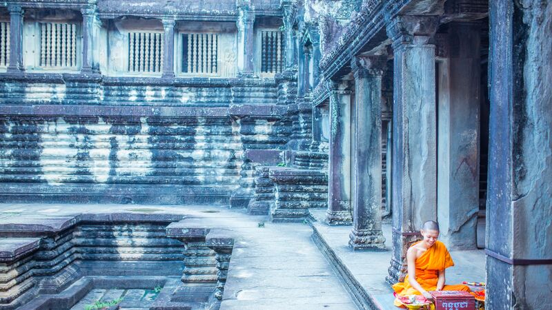 A monk in an orange robe in Cambodia