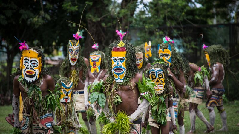 dancers wearing colourful masks in Papua New Guinea