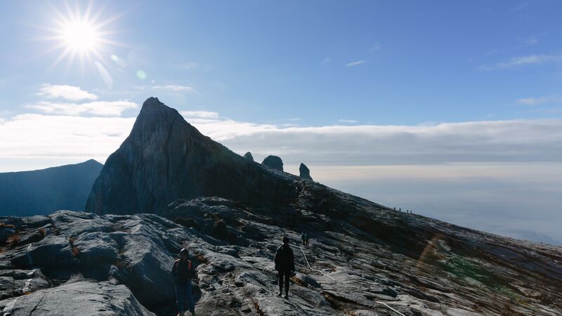 Climber ascending Mt Kinabalu at sunset