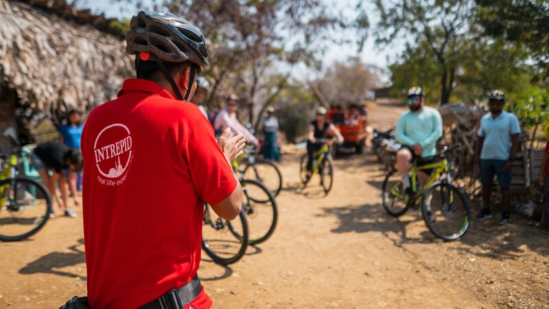 A group of travellers cycling through a community