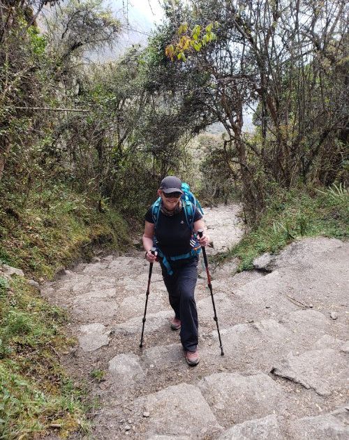 A hiker on the rocky steps of the Inca Trail