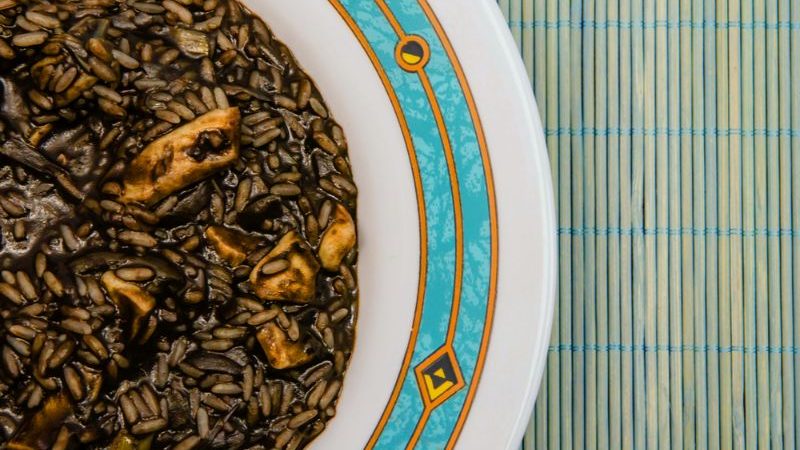 A plate of black rice paella