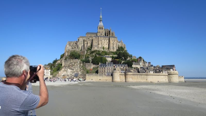A man taking photos of a castle in France