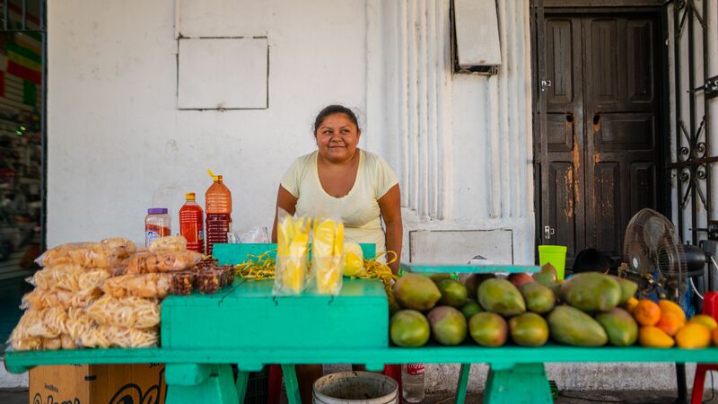 A woman selling mangoes in Izamal, Mexico