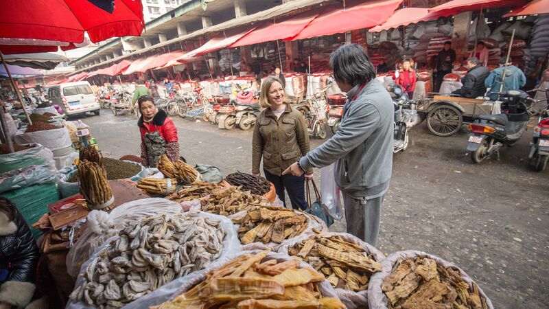 A man points out street food in Chengdu