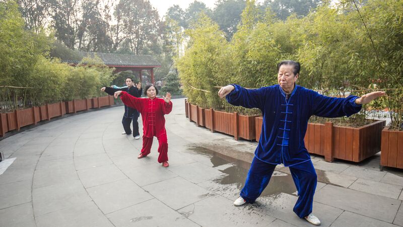 Three people practicing Tai Chi in China