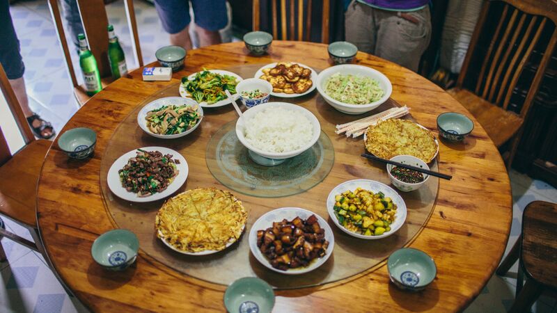 A table covered in plates of food in China