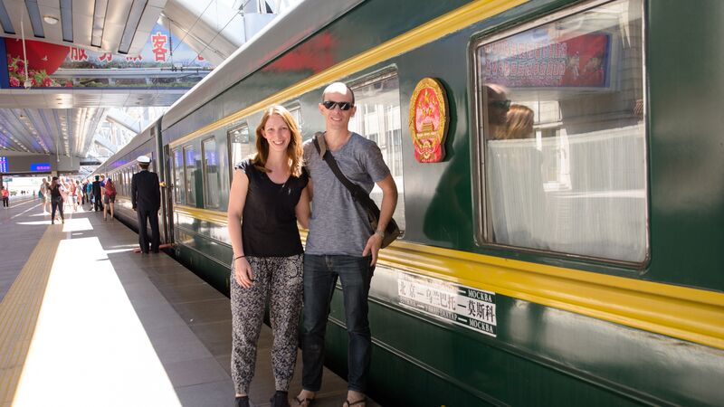 A man and woman getting ready to board a train in China