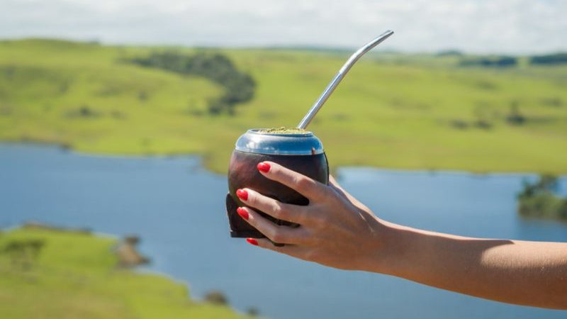 A woman holding a yerba mate