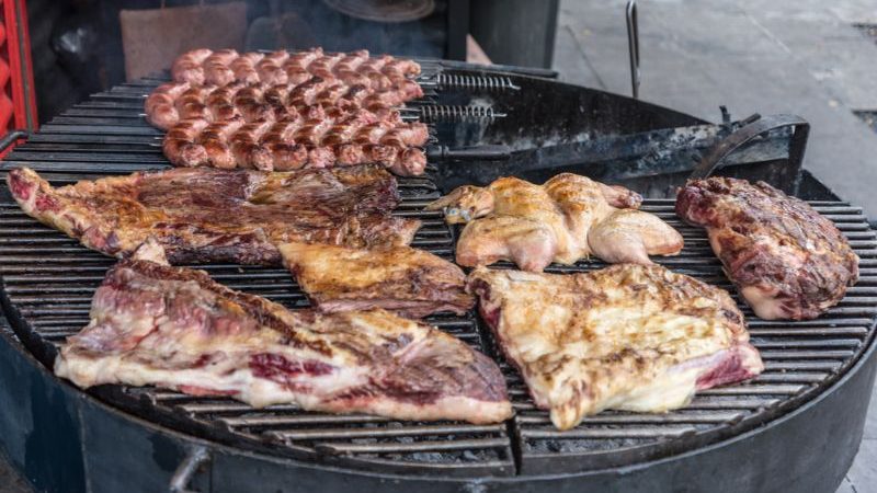 A barbecue covered in meat in Argentina