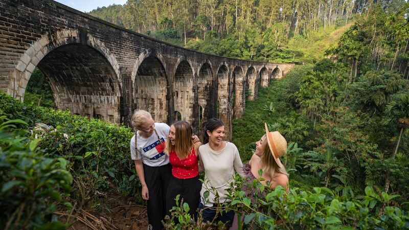 Four women standing in front of a beautiful bridge in Sri Lanka