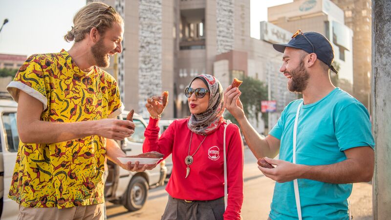 Two yound travellers with their local leader in Egypt