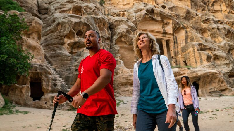 A woman walking around Jordan with a local leader