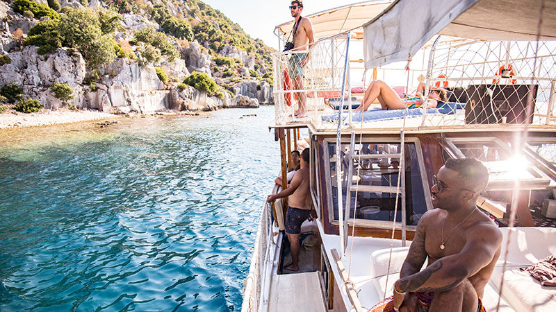 A group of travellers relaxing on a traditional boat in Turkey