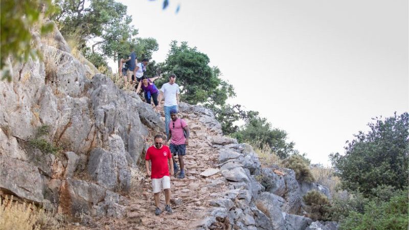 Trekkers making their way down a rocky path.