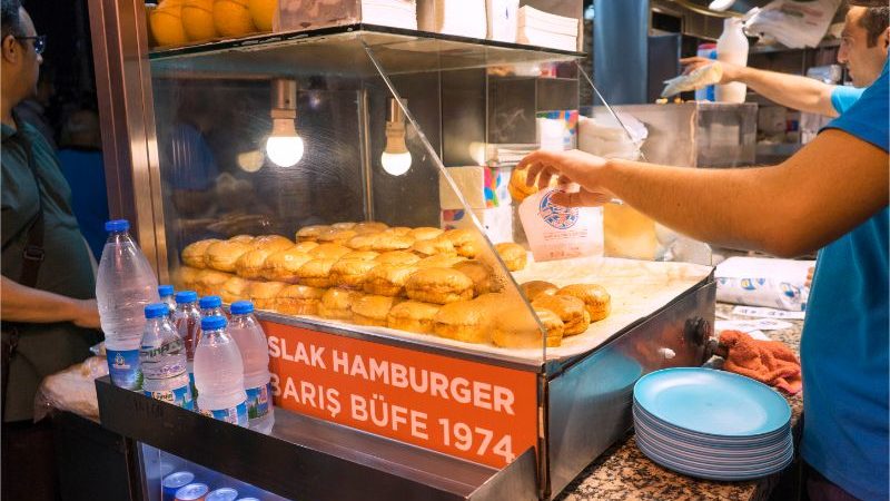 A vendor selling wet burgers in a Turkish market