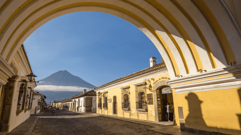 Volcano views through an archway in Antigua, Guatemala