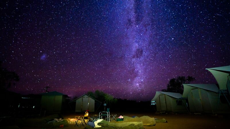 Two campers sleeping under the stars in outback Australia