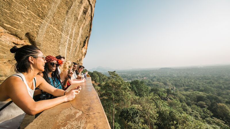 Travellers looking at a beautiful view from a cliff in Sri Lanka