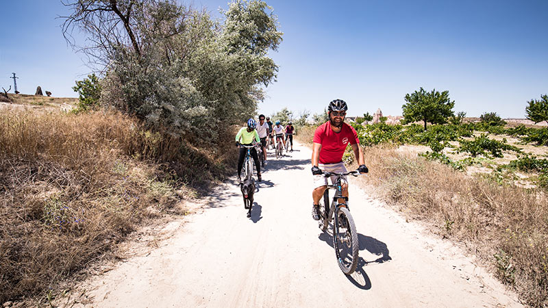 A group of cyclists on a dirt road in Turkey