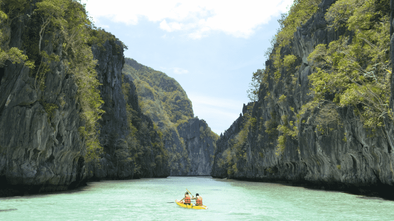 Two travellers kayaking in El Nido, Palawan in the Philippines