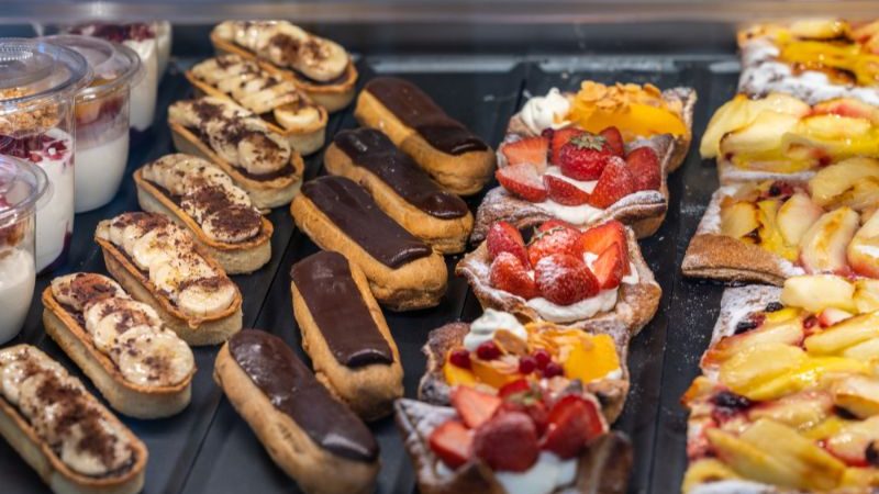 A counter full of French cakes in a patiesserie