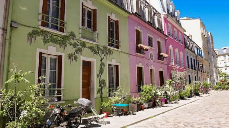 A street in Paris filled with colourful houses.