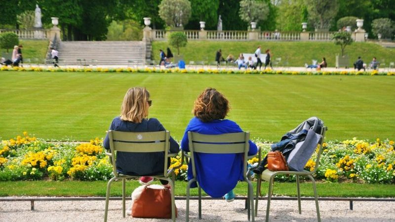 Two women sitting in a park in Paris