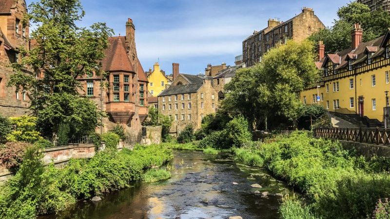 A river runs between houses in Dean Village, Edinburgh