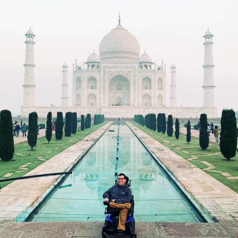 A man in a wheelchair at the Taj Mahal