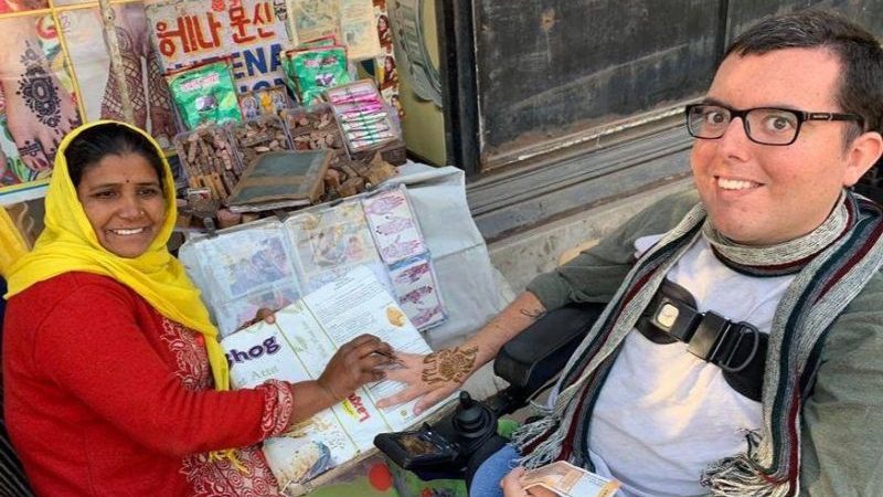 A man getting his hands painted with henna in India