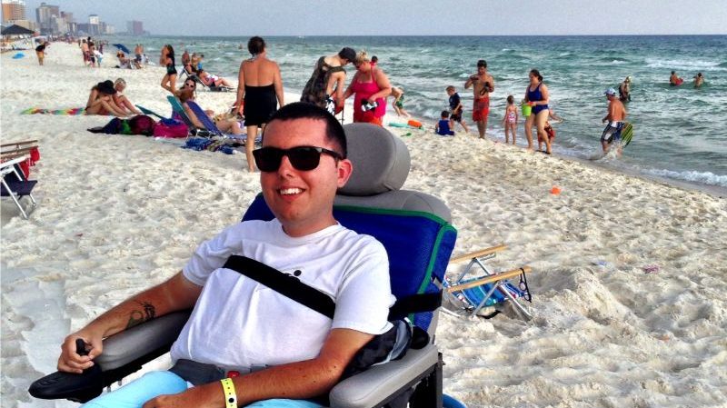 A man in a beach-friendly wheelchair