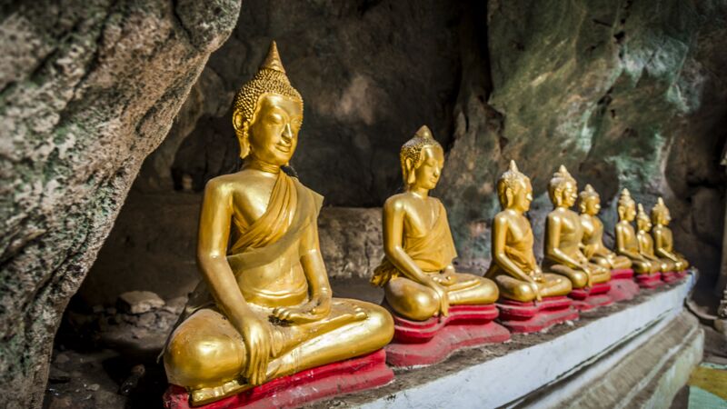 A temple filled with gold Buddhas in a cave