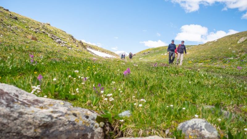 Trekkers walking through a beautiful valley in Mongolia