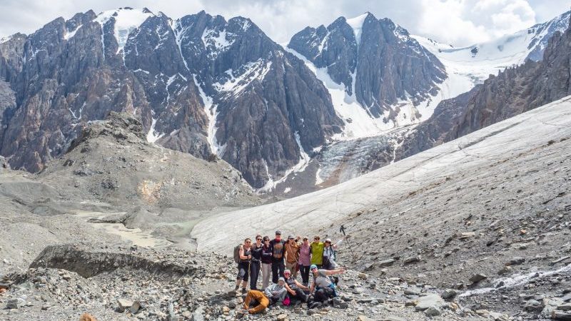 A group of trekkers hiking to a glacier in Russia