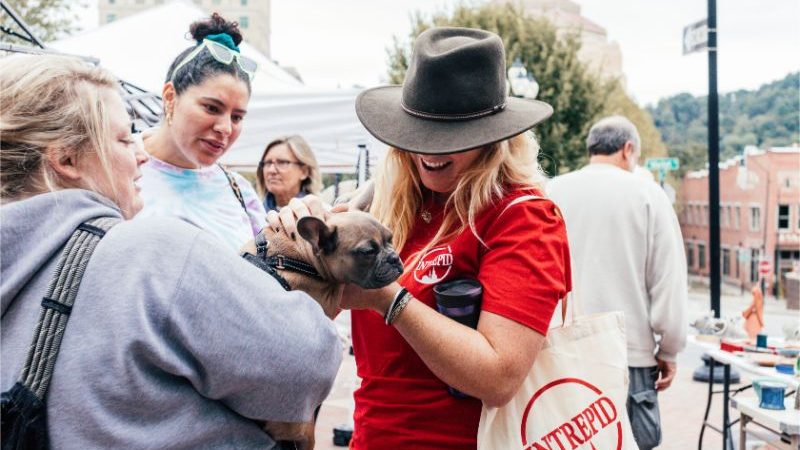 Tour leader patting a small puppy