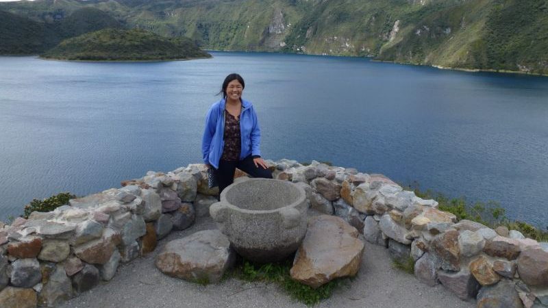 A woman standing at Cuiocha Lake in Ecuador