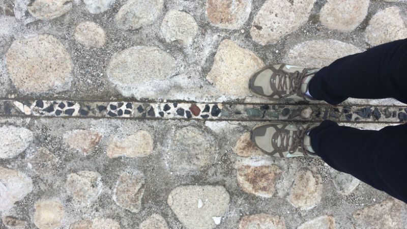 A pair of feet standing on the equator