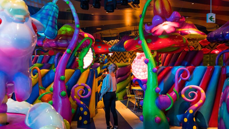 A traveller in a brightly decorated cafe in Tokyo