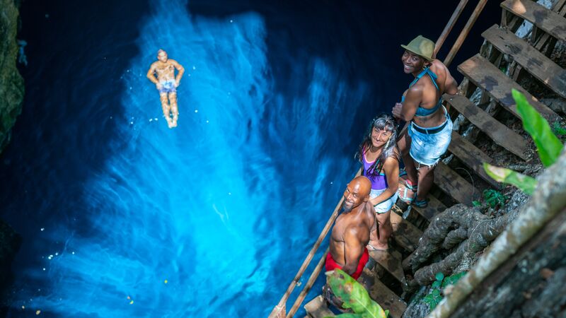 A man floating in a cenote in Mexico