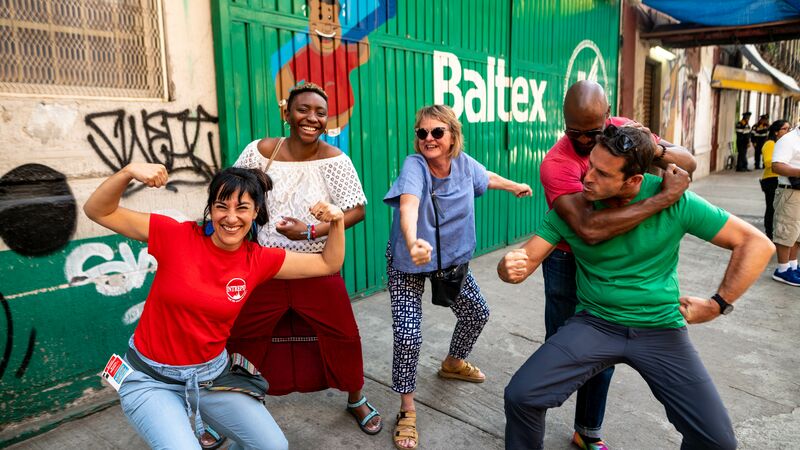 A group of travellers pulling wrestling moves in Mexico