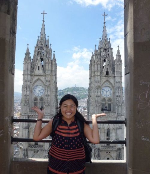 A woman smiling at a church in Quito