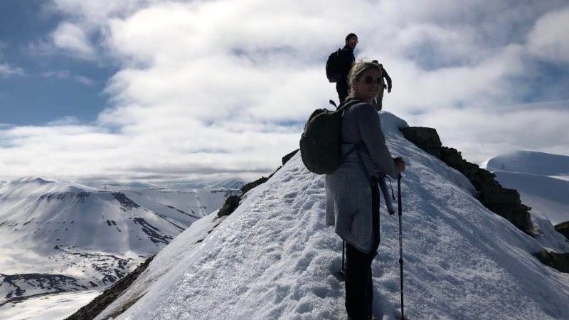 Hikers on a snow-covered mountain in Svalbard